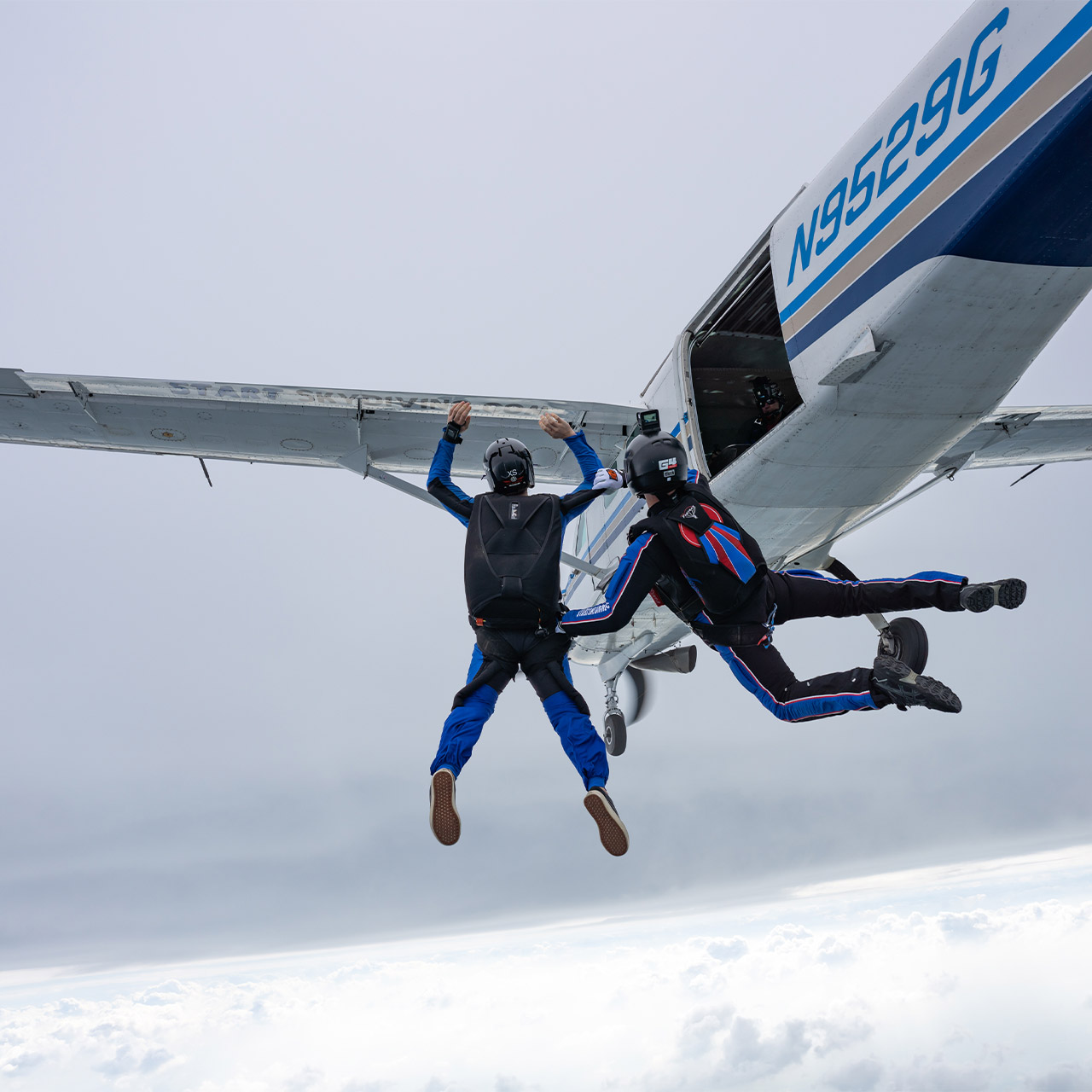 A female learn to skydive AFF student exits the aircraft with her instructor at Start Skydiving in Middletown, Ohio
