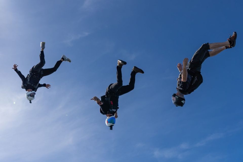 3 licensed skydiver fly in the head down orientation at Start Skydiving.