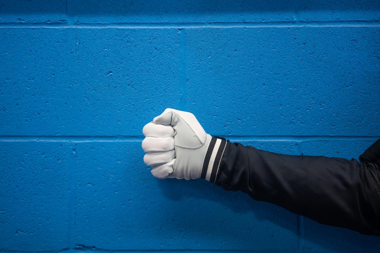 White gloved hand giving the practice touch hand signal