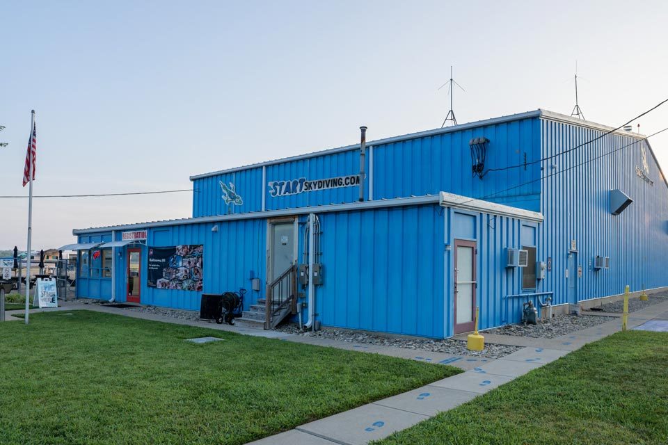 Exterior shot of the blue Start Skydiving hangar.