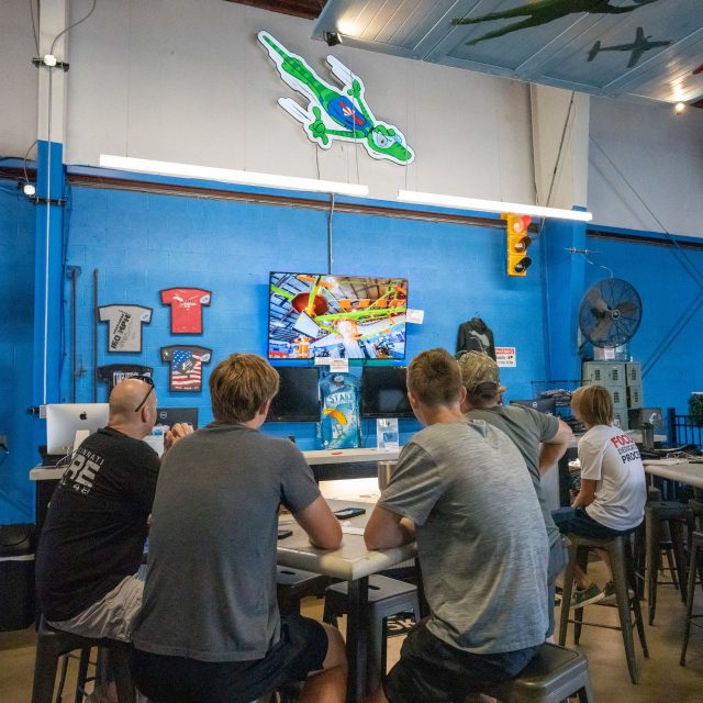 A group of tandem students waiting within the spacious hangar at Start Skydiving