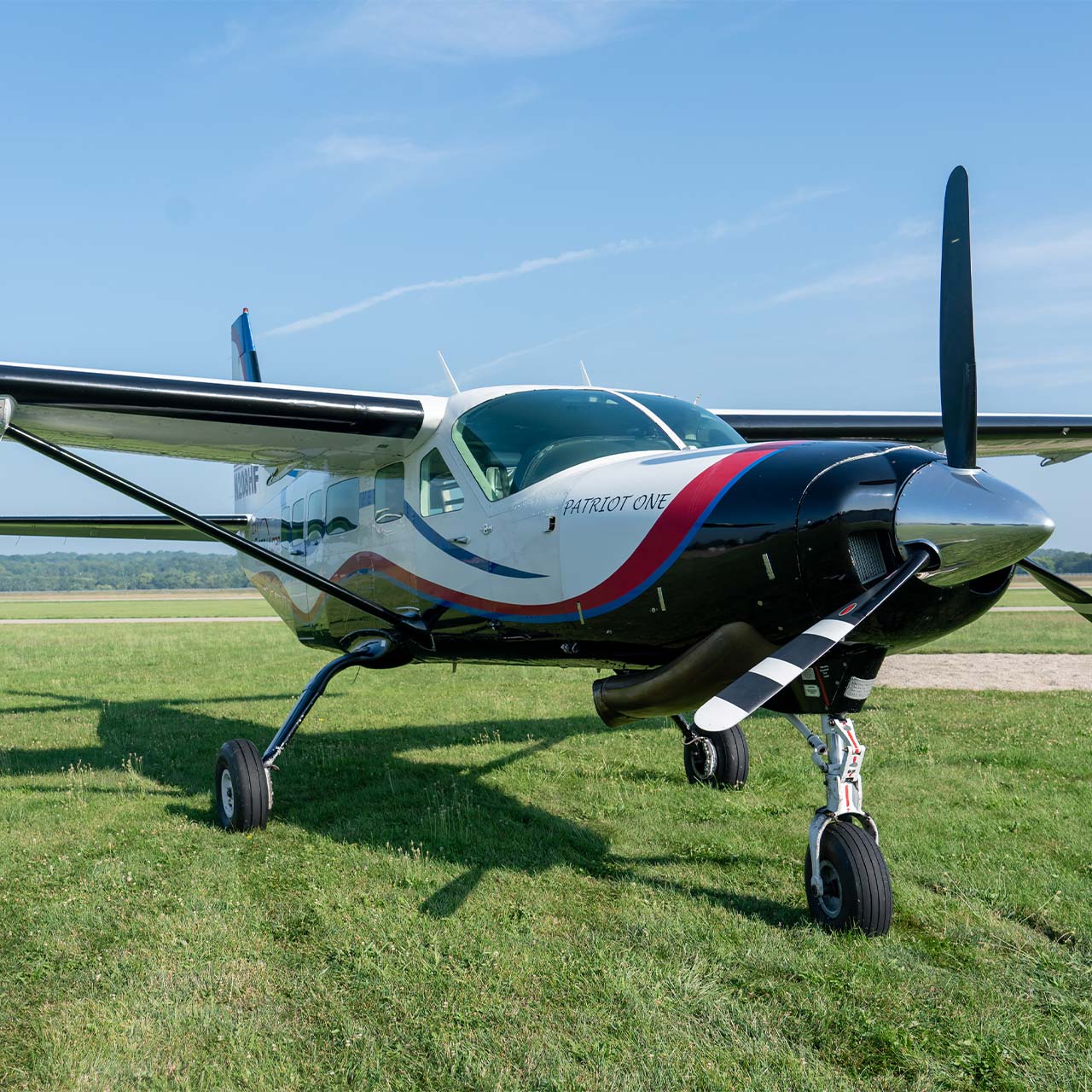 Start Skydiving's blue, white, and red single prop airplane names Patriot One.