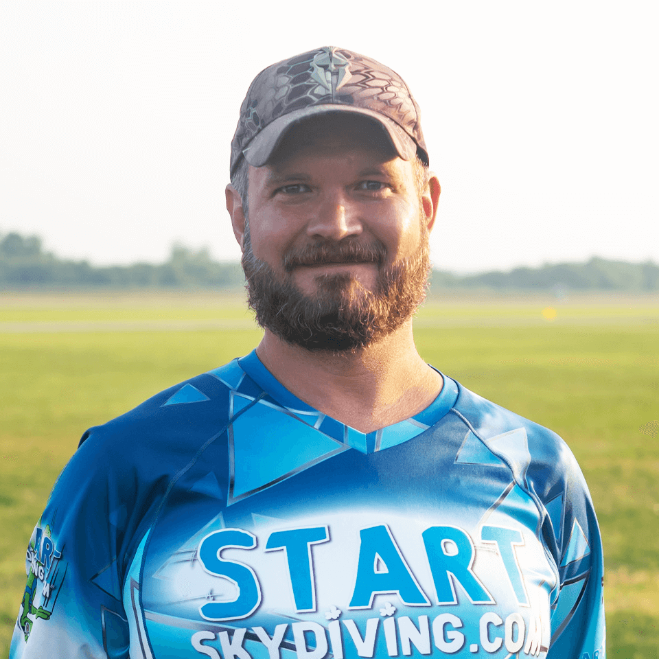 Ean Vonscheerschmidt wearing a hat and a blue Start Skydiving jersey